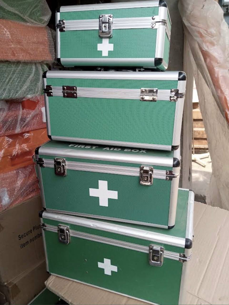 Stack of green aluminium first aid boxes in several sizes